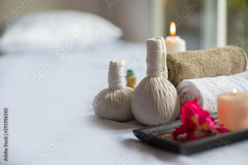  Spa treatments on White spa massage bed with candles, massage oil and Herbal massage cubes