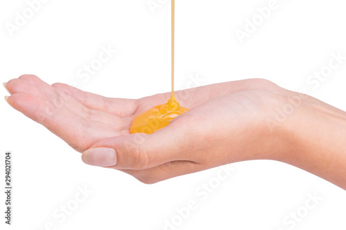 Yellow shampoo pouring on a female hand