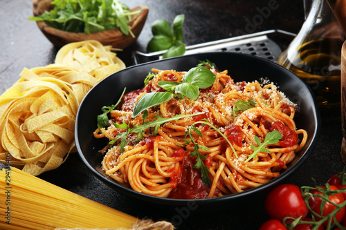 Plate of delicious spaghetti Bolognaise or Bolognese with savory minced beef and tomato sauce garnished with parmesan