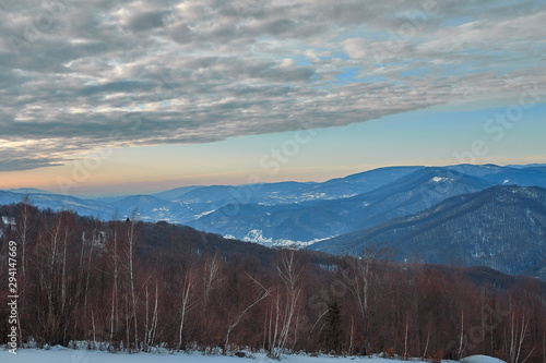 Carpathian mountains in the clouds, beautiful beech forests, in winter, saturated colors, contrasting colors