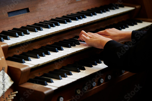 A woman playing the pipe organ 