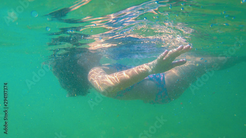 Underwater view from a girl diving in the ocean water