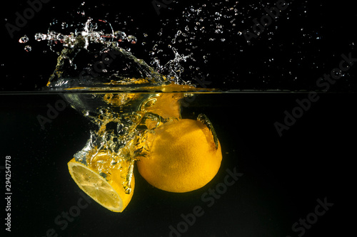 Lemon splashing into water