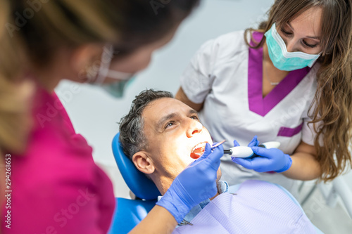 Team of Dentist Doing a Prophylaxis to a Patient.