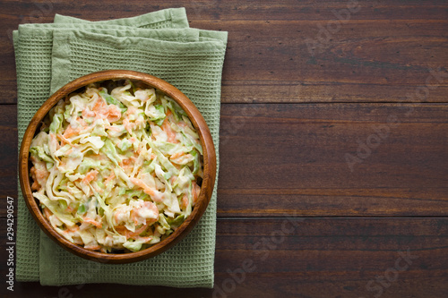 Coleslaw made of freshly shredded white cabbage and grated carrot with homemade mayonnaise-based salad dressing, photographed overhead with copy space on the side (Selective Focus, Focus on the salad)