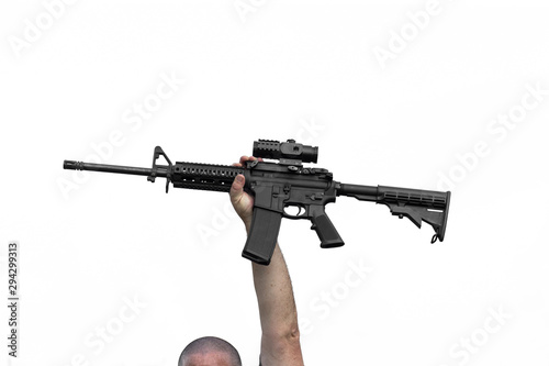 Man Holding AR-15 or AR-16 Automatic Assault Rifle In Air Above His Head