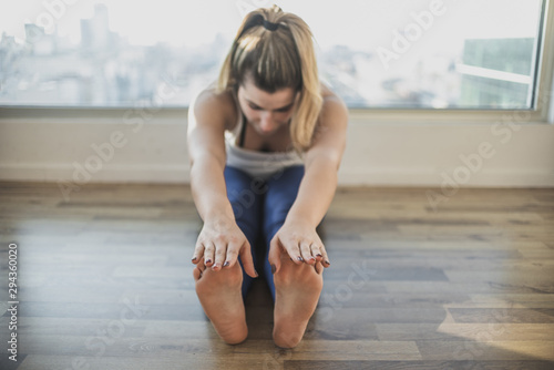 Fit young girl doing stretching
