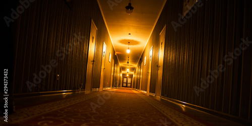 long dark vintage motel corridor with closed doors