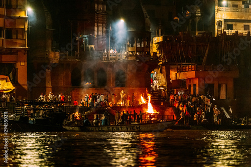 The burning bodies ceremony at holy Dasaswamedh Ghat, near Kashi Vishwanath Temple while raining at night, Varanasi, India.