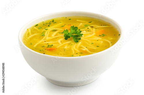 Instant chicken noodle soup in a white ceramic bowl isolated on white. Parsley garnish.