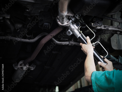 Hand of auto mechanic working in garage. Repair service Steering rack.