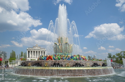 Moscow, Russia - may 7, 2019: Fountain "Stone flower" on the background of pavilion No. 64 "Optics" at VDNH