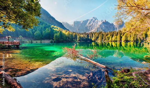 Colorful summer view of Fusine lake. Bright morning scene of Julian Alps with Mangart peak on background, Province of Udine, Italy, Europe. Traveling concept background.