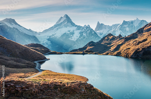 Gorgeous evening panorama of Bachalp lake / Bachalpsee, Switzerland. Exotic autumn sunrise in Swiss alps, Grindelwald, Bernese Oberland, Europe. Beauty of nature concept background.