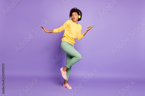 Full length body size view of nice attractive charming dreamy funky funny cheerful wavy-haired girl listening soul dancing having fun isolated over violet purple lilac pastel color background