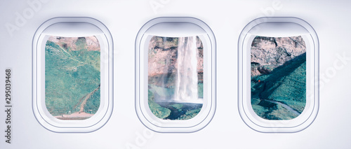 Airplane interior with window view of Seljaland Waterfalls, Iceland. Concept of travel and air transportation