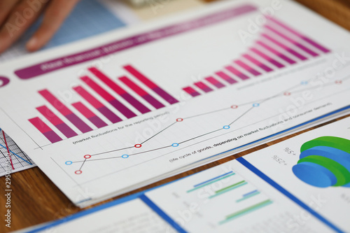 Close-up of biz documents with statistics data in charts, graphs and diagrams. Financial forecast of growth income. Stock Exchange, Securities Market concept. Blurred background