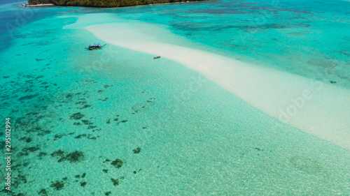 Sandy beach with tourists among turquoise waters and coral reefs. Mansalangan sandbar. Beach at the atoll. Summer and travel vacation concept. Balabac, Palawan, Philippines.