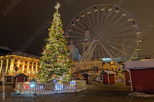 Romantic Christmas market with New Year Tree in Kyiv, Ukraine. The Ferris wheel and Christmas decoration at the Kontraktova Square on Podil. Morning landscape without people