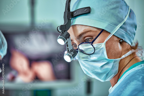 Female surgeon in operation room with reflection in glasses