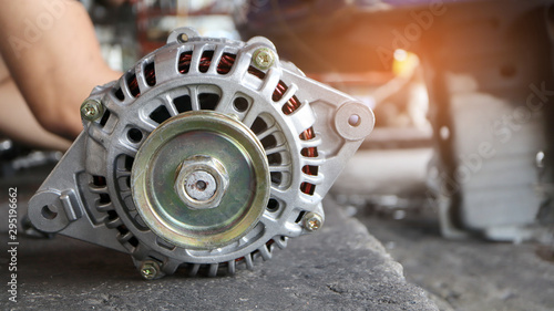 Change new car alternator in the garage or auto repair service center, as background automotive concept.