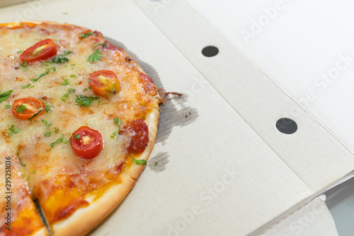sliced vegetarian pizza - traditional fast food in peper box open.