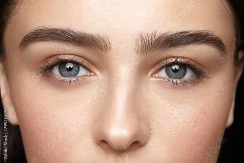 girl with nude make-up with blue eyes closeup