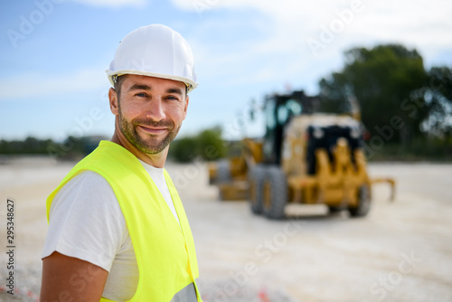 portrait of handsome foreman construction worker on a industrial building industry construction site