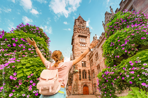 A girl traveler enjoys a view of the town hall building in Saarbrücken. Travel in Germany concept