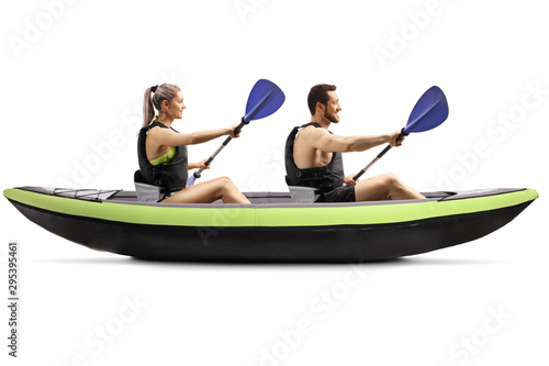 Profile shot of a young man and woman kayaking