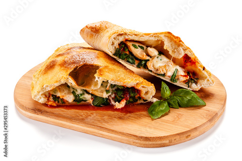 Pizza calzone on cutting board on white background