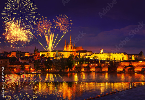 Colorful massive fireworks show over the Prague Czech Republic. Celebration concept Christmas, New Years Eve 2020. Panoramic shot of the night city with lights and reflection in the water. December 31