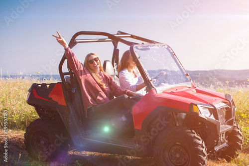 two young women driving a off road buggy car