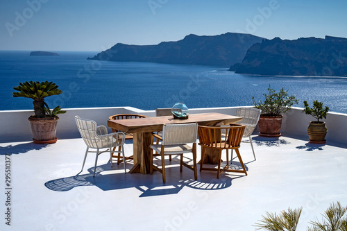 Romantic mediterraen vacation lunch on a rooftop over the sea in Santorini