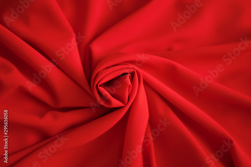 Red batiste made of cotton. sample of red soft fabric with pleats. Top view