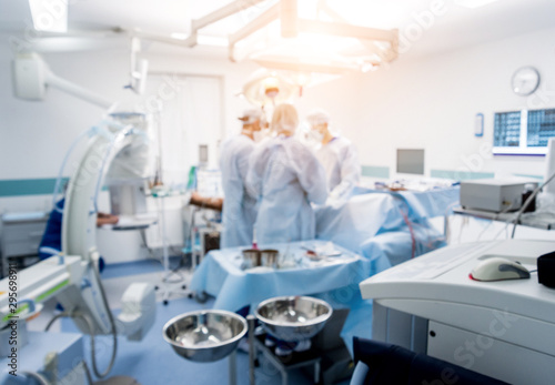 Spinal surgery. Group of surgeons in operating room with surgery equipment. Laminectomy