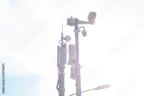 A column filled with surveillance cameras, cellular transmission stations, television transmitters and wifi transmitters in the bright sun