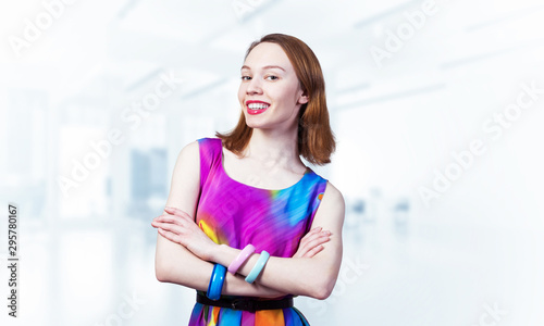 Happy woman standing with folded arms