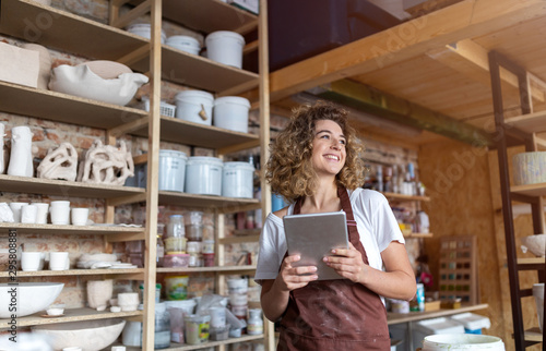 Craftswoman with tablet computer in art studio 