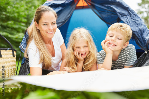 Mother and two children in front of the tent