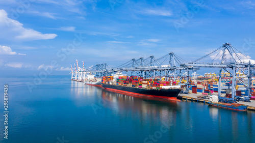 Container cargo ship at industial port in import export business logistic and transportation of international by container cargo ship in the open sea,