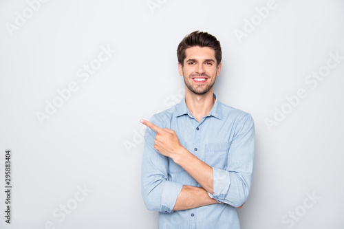 Portrait of positive cheerful guy promoter point index finger recommend ads select suggest adverts wear casual style clothes isolated over grey color background