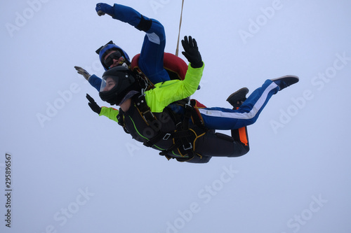 Skydiving. Tandem jump. An instructor and a passenger are flying in the sky.