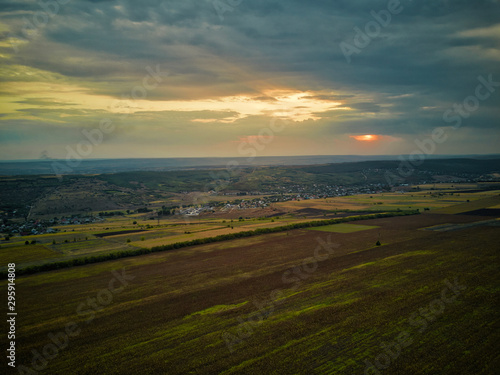 Aerial drone view of grain fields, wheat during golden sunset. Agricultural pattern. Moldova republic of.