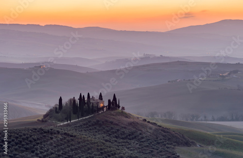 The Tuscan countryside in the province of Siena shrouded in morning mist before the dawn of a new day