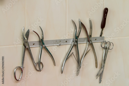 medical instruments hanging on a suspension mounted on a wall