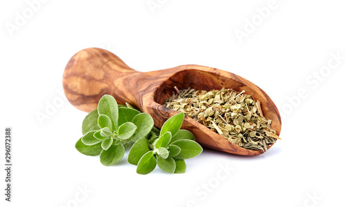 Oregano or marjoram leaves isolated on white background. Oregano fresh and dry in wooden spoon.