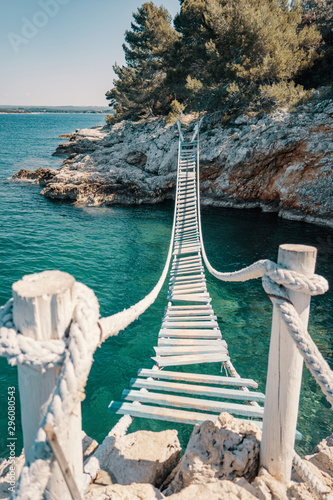 Rope bridge over a cliff in Punta Christo, Pula, Croatia - Europe. Travel photography, perfect for magazines and travel destination articles.