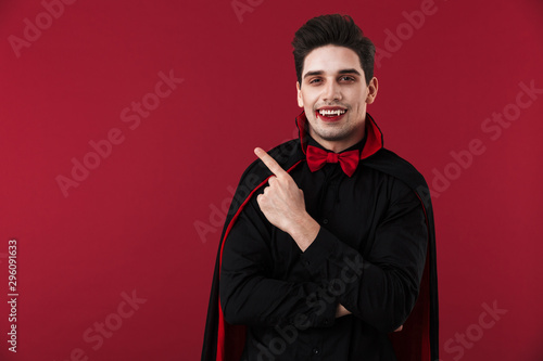 Image of vampire man in black halloween costume pointing finger