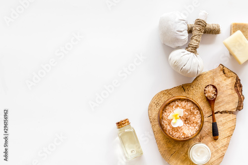 Spa set with massage herbal balls in wellness salon on white background top view frame copy space